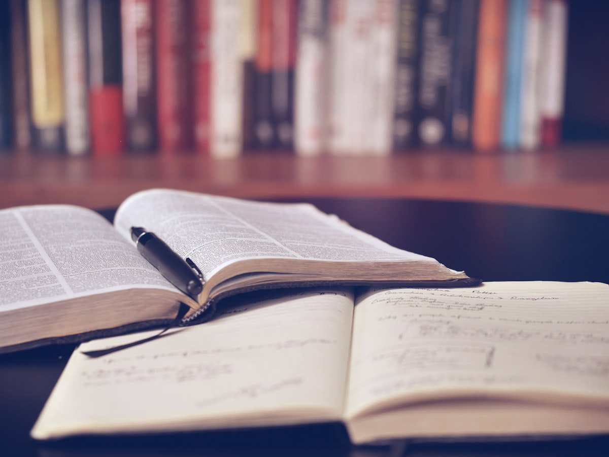 Open journal and pen — tracking your cycle and body patterns