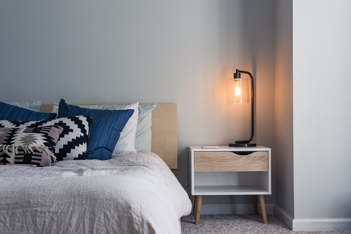 Calm bedroom with made bed — restorative sleep as healing